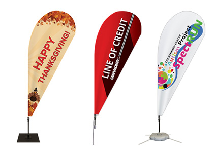 Portable teardrop flag set up for instant advertising outdoors.