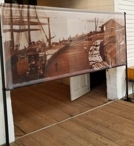 Lightweight, semi-transparent mesh banner display for museum or art exhibits.