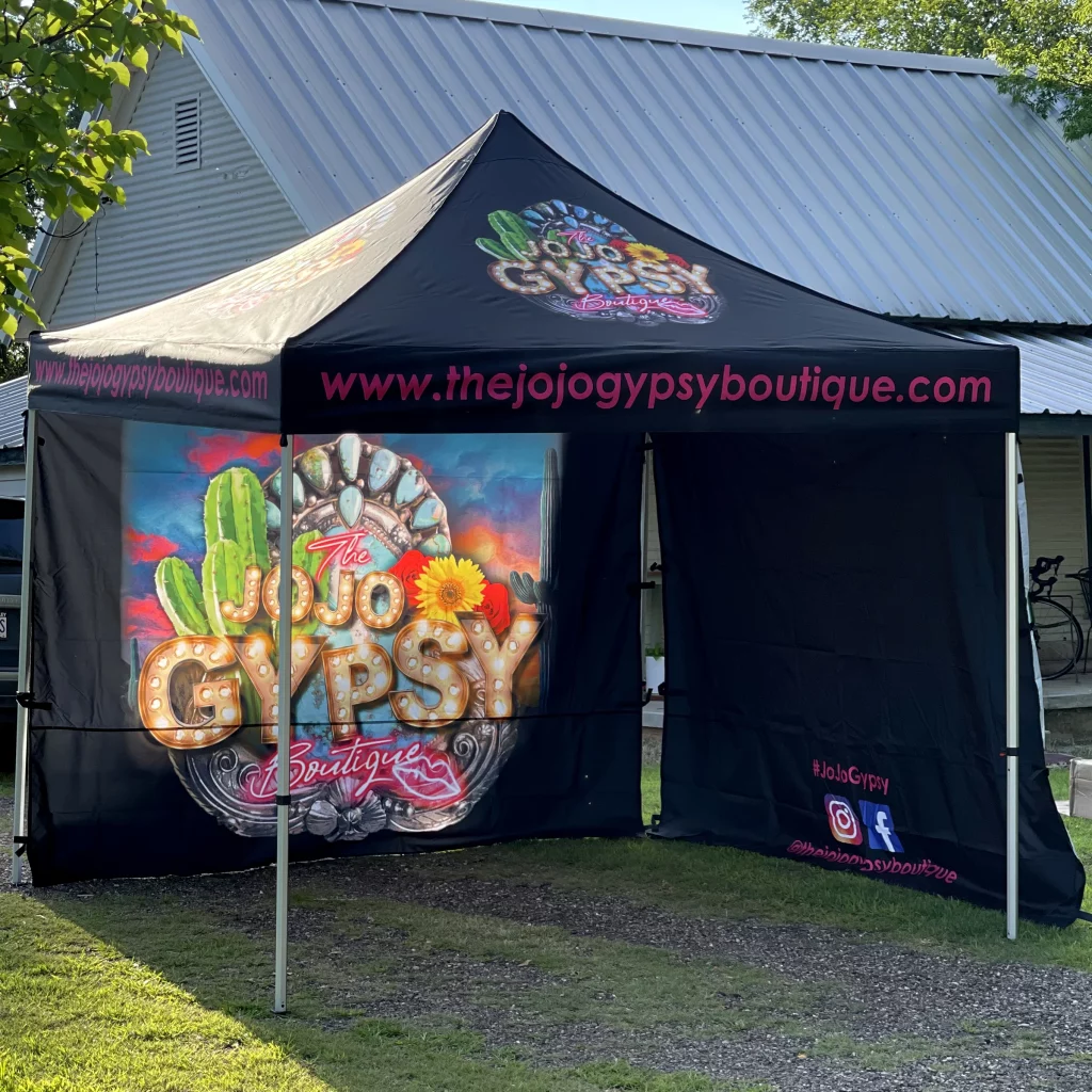 Jojo Gypsy outdoor canopy tent featuring vibrant branded design and event setup.
