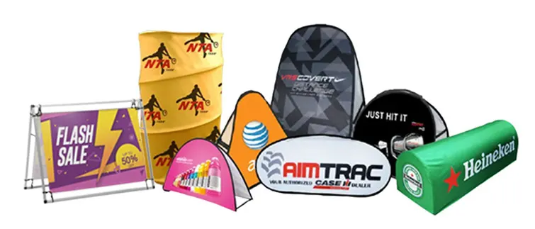 Pop-up A-frame sideline banners displaying branded graphics at an outdoor event.