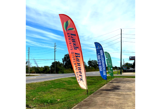 Feather flags promoting business or event with eye-catching vertical banner designs.