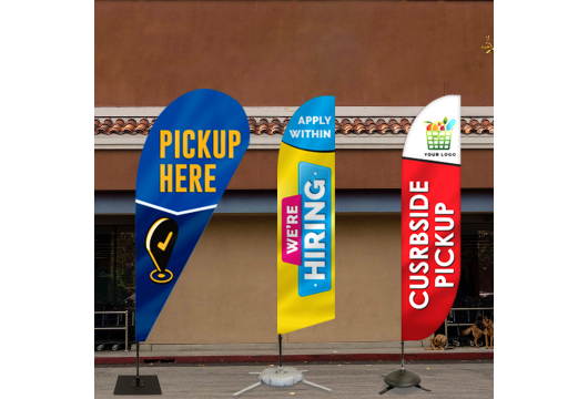 Branded feather flags with messages like Pickup Here displayed outdoors.