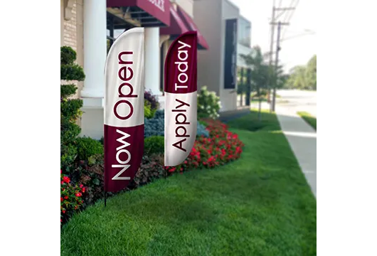 Feather flags strategically placed to maximize brand visibility at an outdoor event.