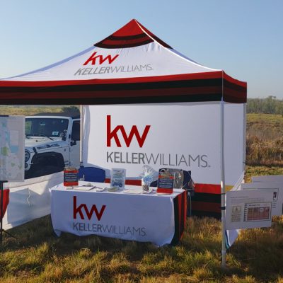 Custom pop-up tent at an outdoor event, showcasing brand presence.