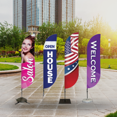 Pre-designed feather flags with messages like Now Open and Pickup Here displayed outdoors